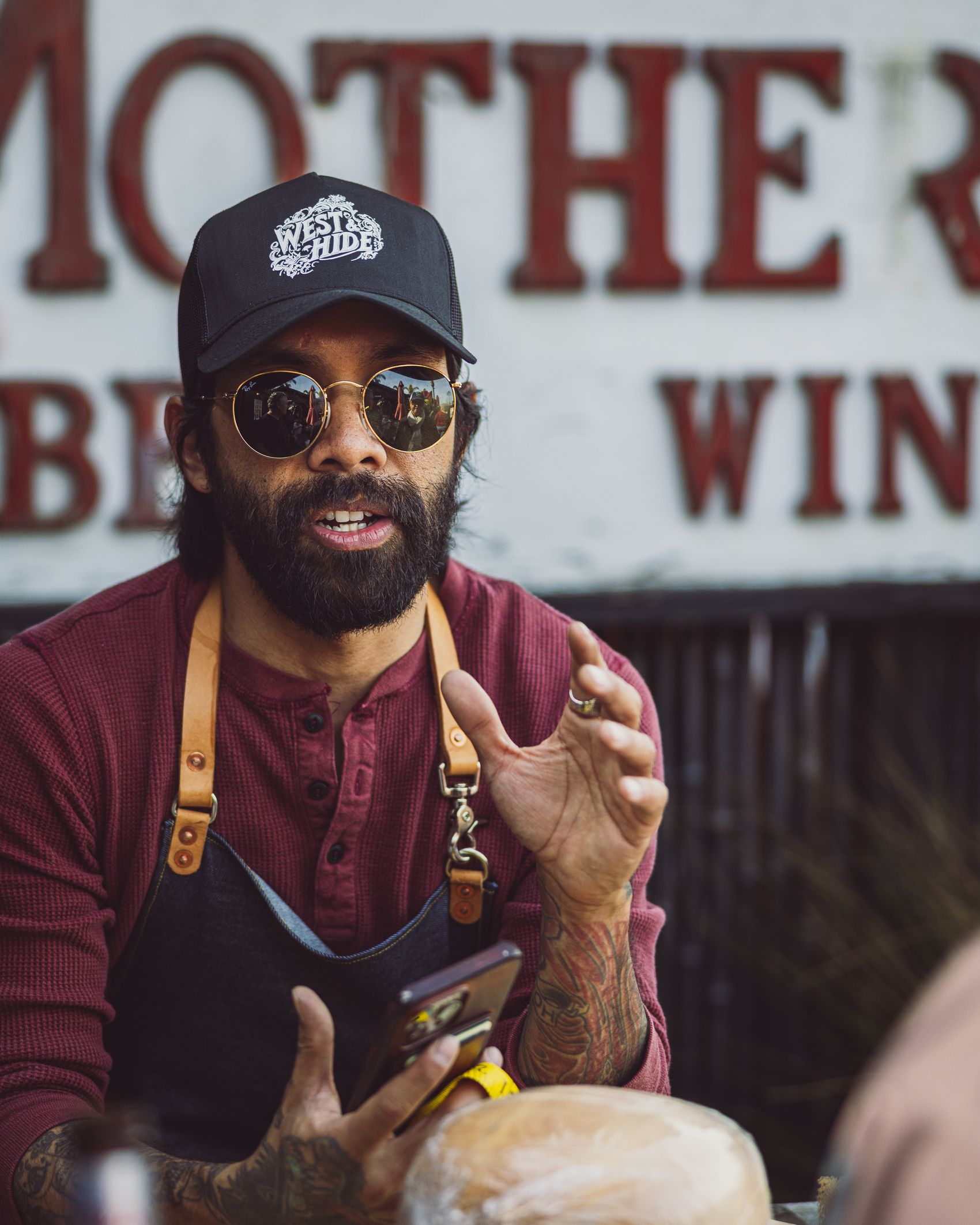 Maker wearing a branded West & Hide trucker cap